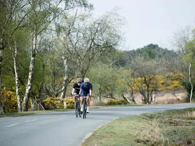 two cyclists riding fast