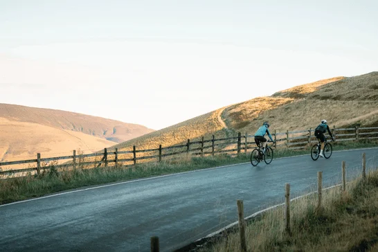 Two cyclists riding together in the peak district